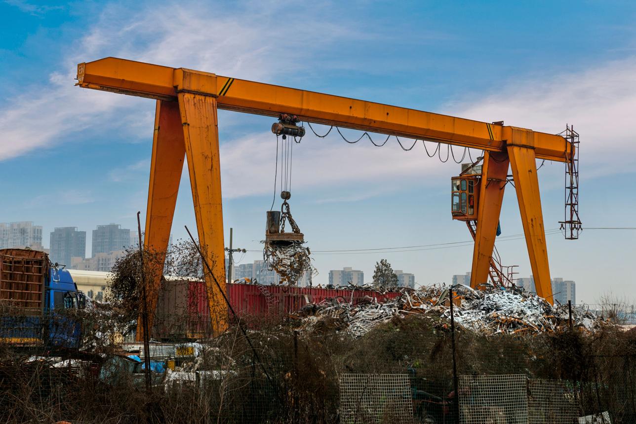 Industrial scrap handling yard with crane