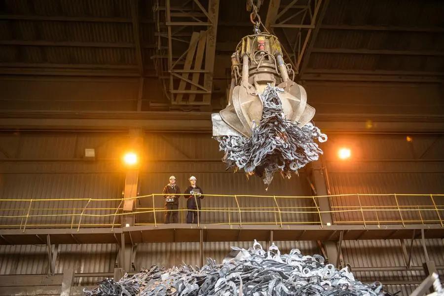 Scrap metal handling crane in an industrial facility
